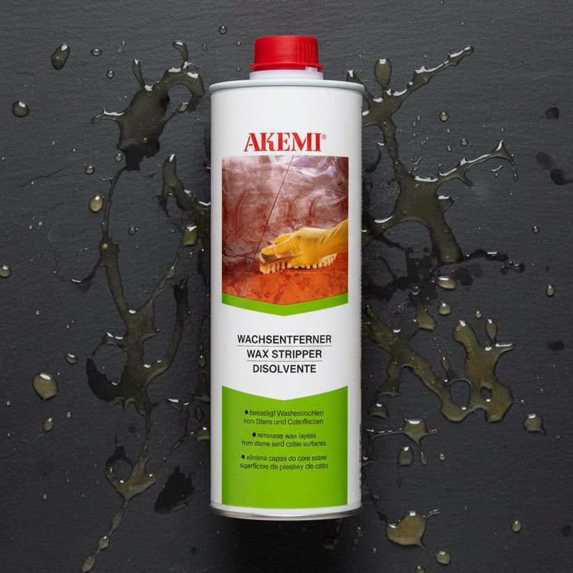 A bottle of Akemi Washer Descaler, designed for removing limescale and grease from various surfaces.