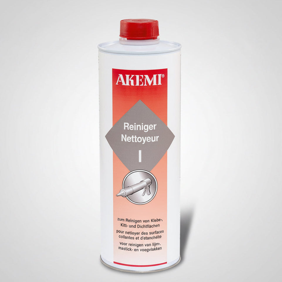 A white bottle with a red cap labeled 'Akemi Rengjørmittel', which is a cleaning agent intended for removing grease and dirt.