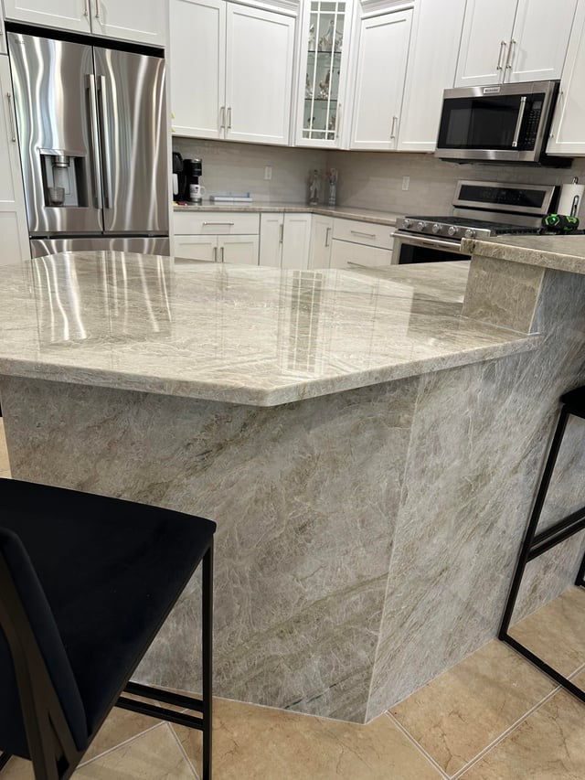 Modern kitchen with marble island and stainless steel appliances